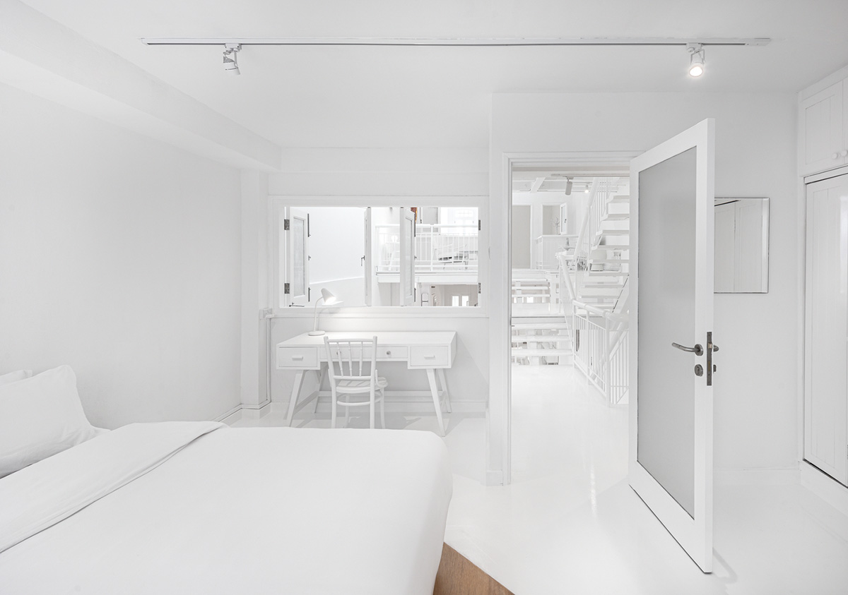 Ministry of Design transforms old dwelling in Singapore into co-living house with all-white interiors