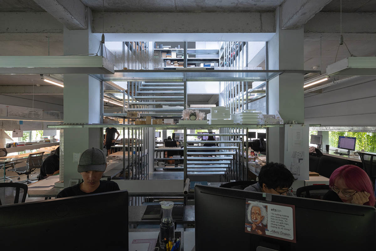 MIA Design Studio created vertical open library inside its office filled with greenery in Vietnam