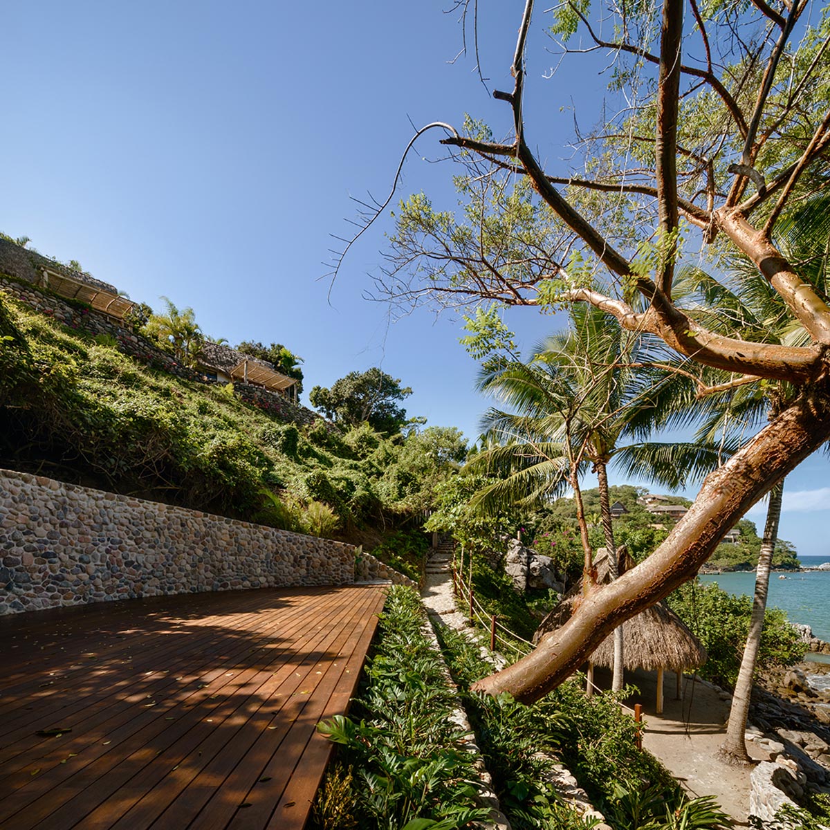 MAIN OFFICE adds half-circle yoga platform to thatched-roof guest villas in Sayulita, Mexico