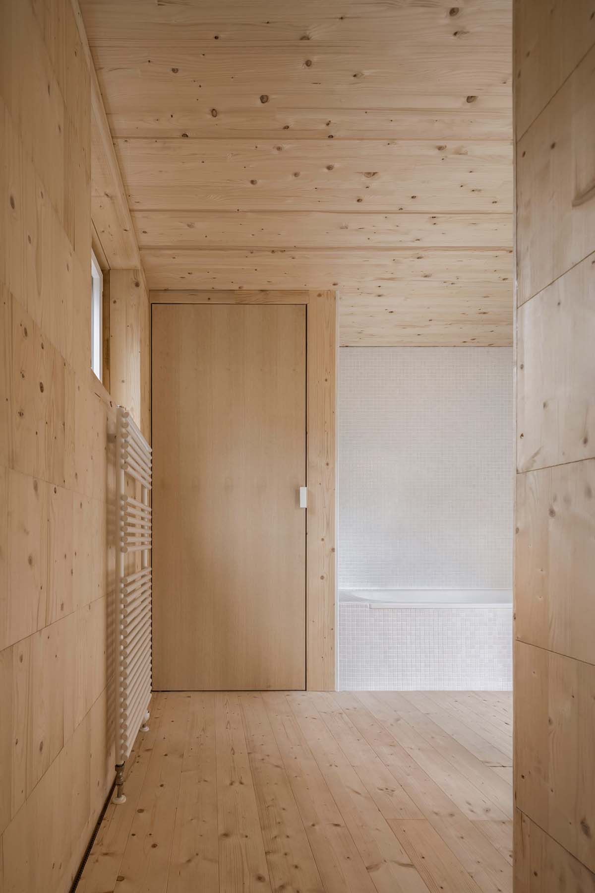 Zeller & Moye built private residence composed of interlocked timber cabins among pine trees