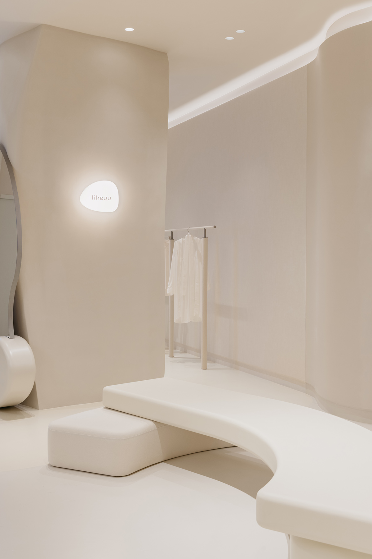 Store interiors by Sò Studio feature soft beige tones to give the feeling of