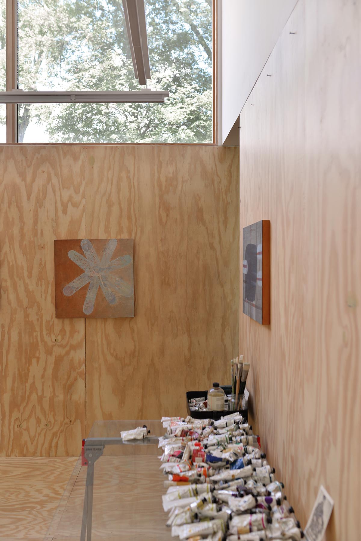 An artist's studio floats and illuminates in the landscape in Germantown