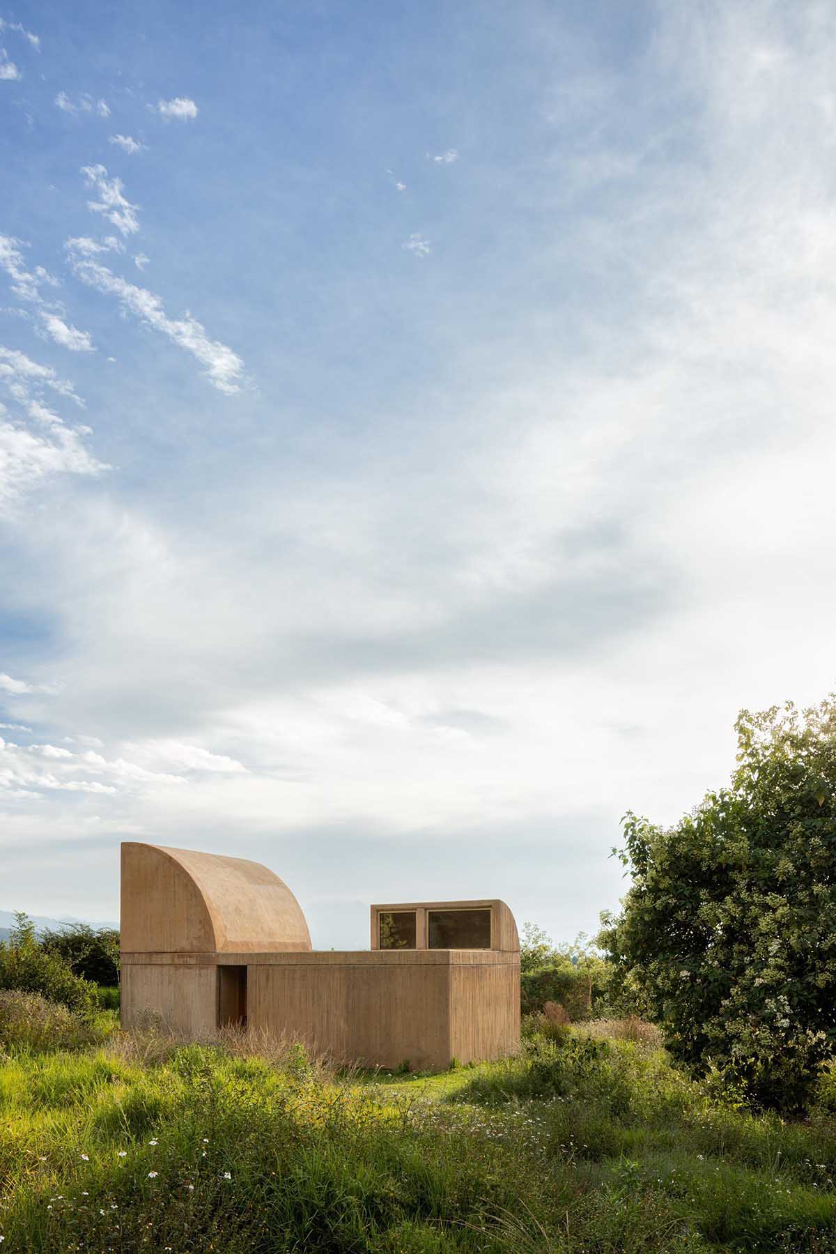 Fernanda Canales creates a circular home framing a mountain and a volcano in Mexico