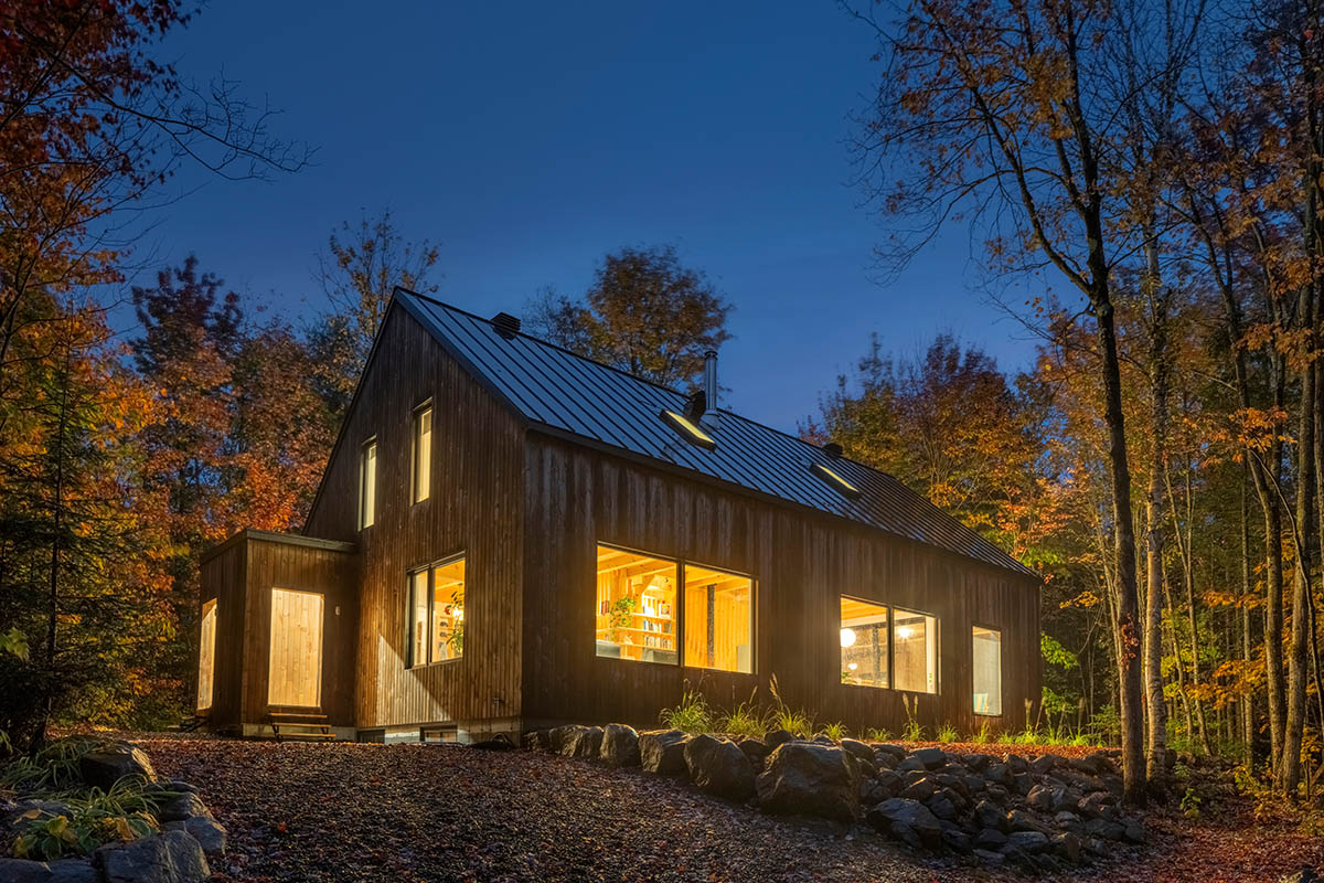 Country home is a wooden shelter that brings tranquility in the heart of the forest in Canada