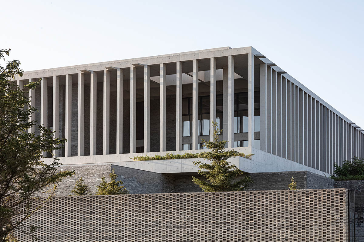 Grey brick walls wrap a factory building referencing to local construction methods in China 