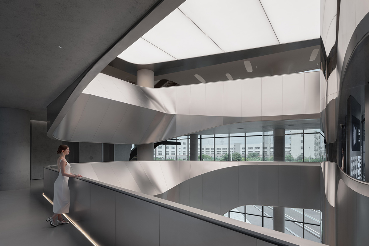 E Studio takes visitors into space travel with a flow of sculpted stainless steel for a showroom