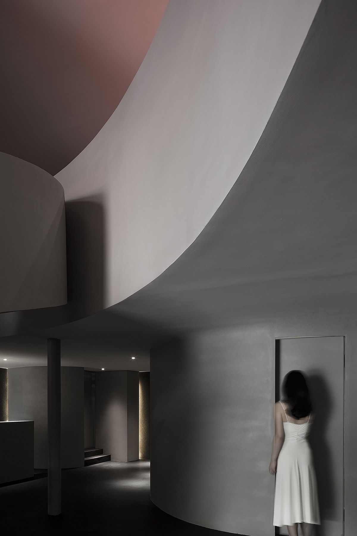 A beauty salon by AD ARCHITECTURE features dark-hued interiors drawing inspiration from cells