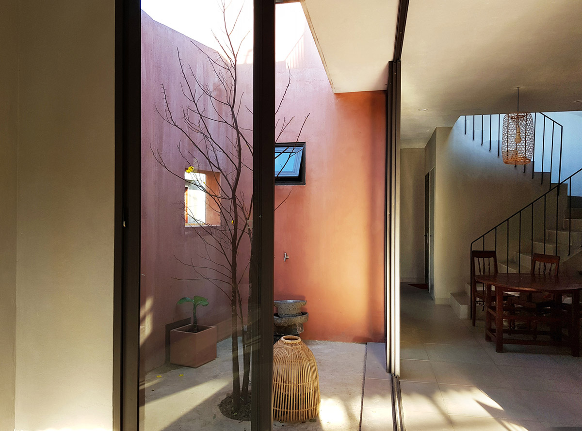 This reddish house features rooftop garden to make owners grow their own food in Vietnam