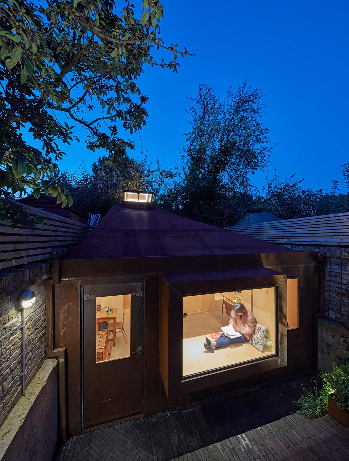 RISE Design Studio built sunken garden studio with rusted steel to provide a hidden place to escape