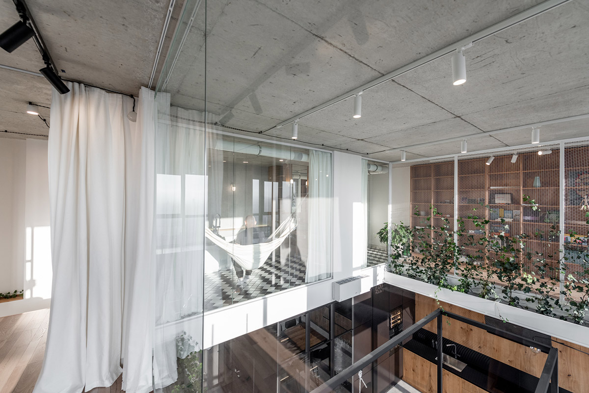 Metal framed-table, glass partitions, green infills make this interior space vivid and light in Lviv