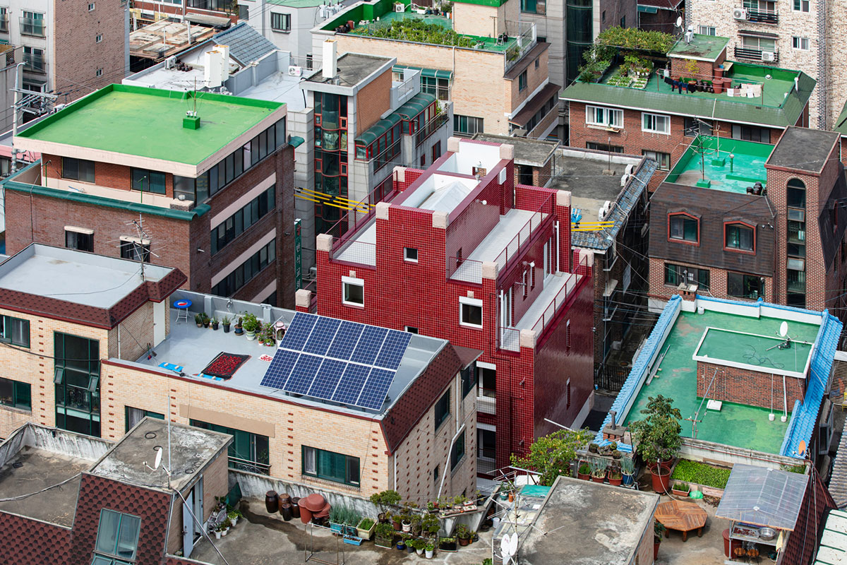 aoa architects uses red marble tiles to clad this apartment in South Korean neighborhood