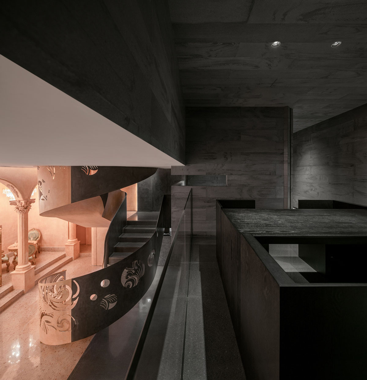 Pink elements and dark colors create sharp contrast in the interiors of restaurant and showroom