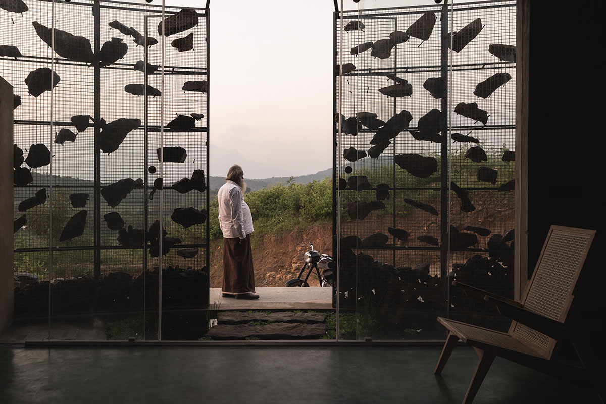 Farm house by Earthscape Studio is wrapped by gabion wall to filter light and airflow in India 