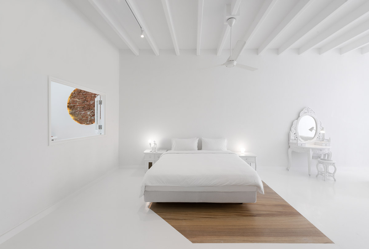 Ministry of Design transforms old dwelling in Singapore into co-living house with all-white interiors