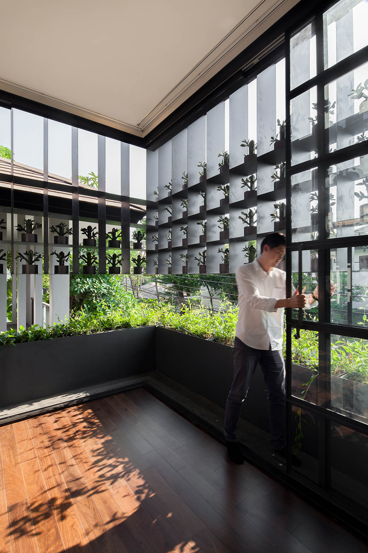 Anonym Studio renovated Bangkok’s old house with steel flower beds to create more openness