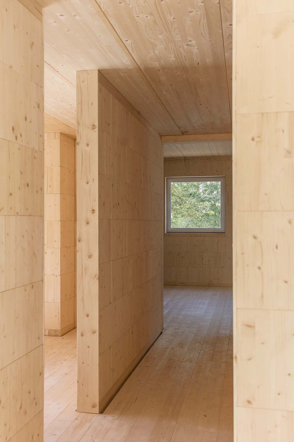 Zeller & Moye built private residence composed of interlocked timber cabins among pine trees