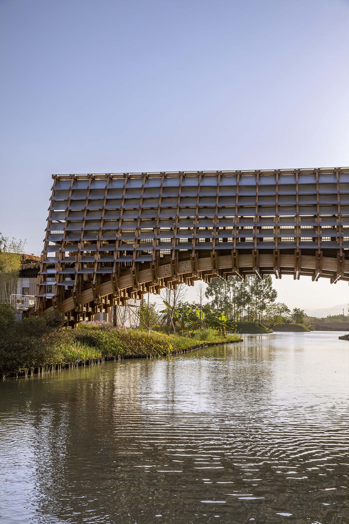 Arched timber bridge by LUO studio allows boats to pass under bridge smoothly in Gulou waterfront