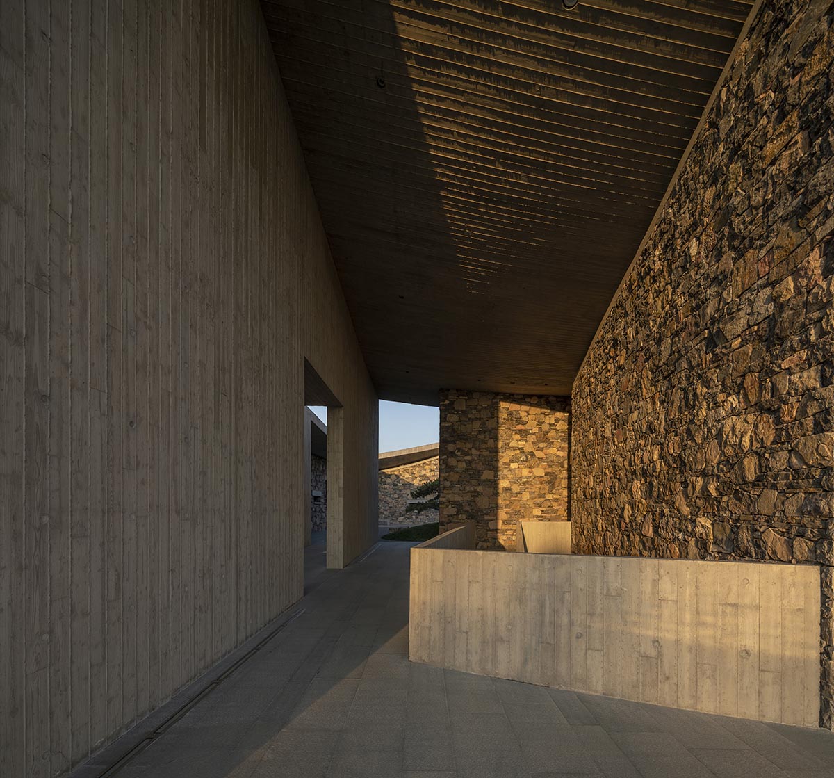 Concrete hyperboloid roofs cover masonry stone art center with a central courtyard in Shandong