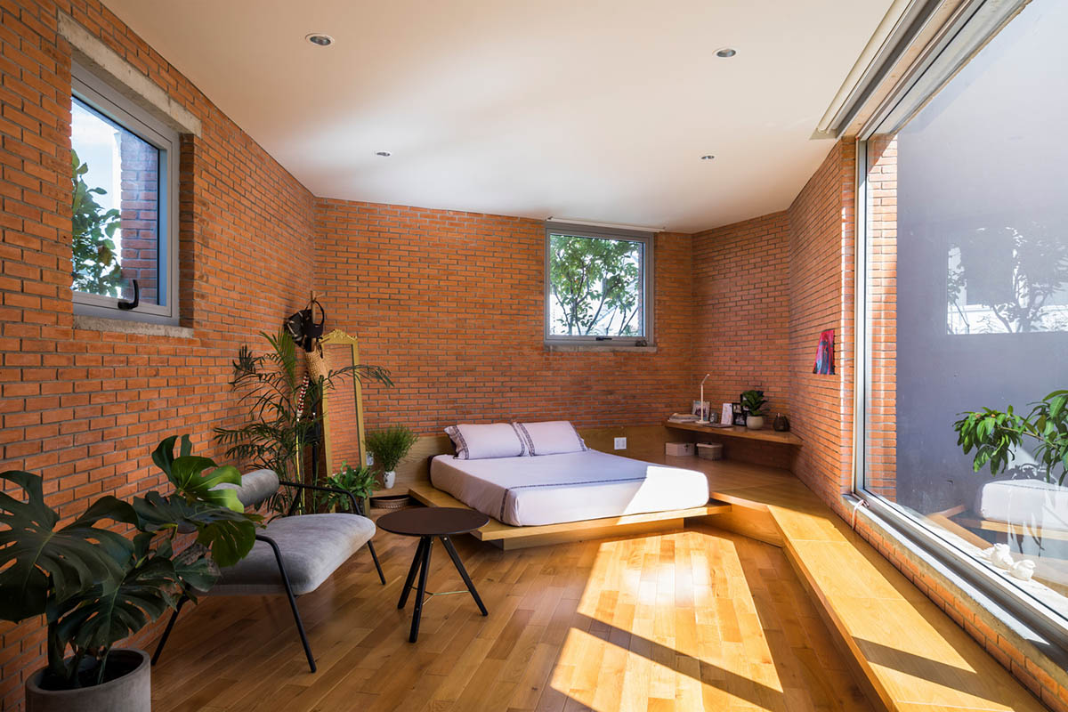 VTN Architects' new cascading family house creates large green gardens in a narrow site of Vietnam