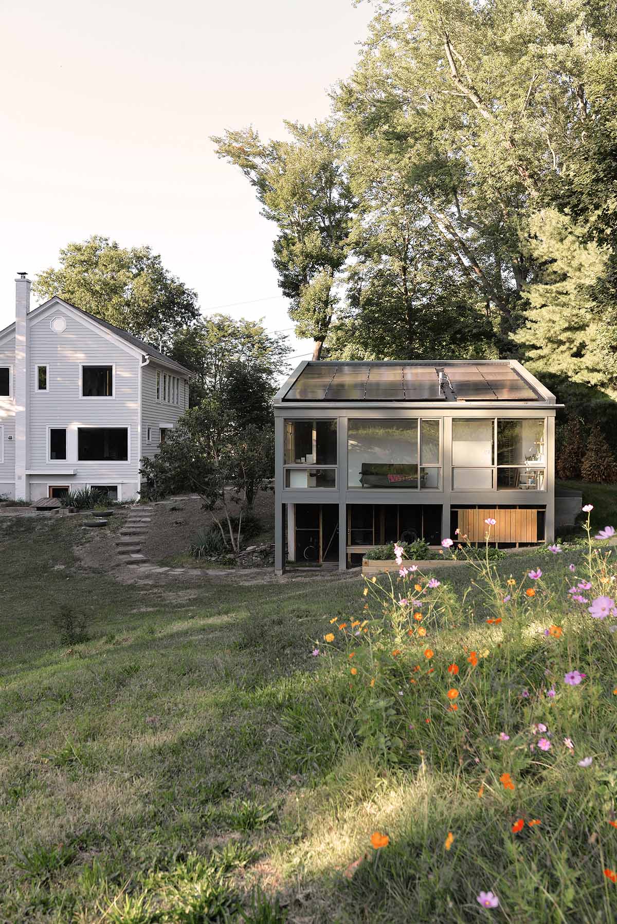 An artist's studio floats and illuminates in the landscape in Germantown