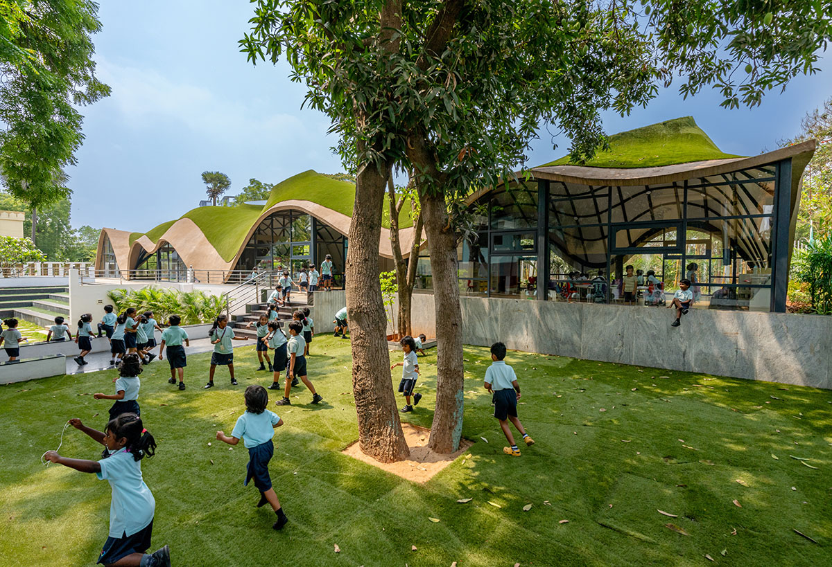 Undulating roof covers Cocoon School for unobstructed space in India 