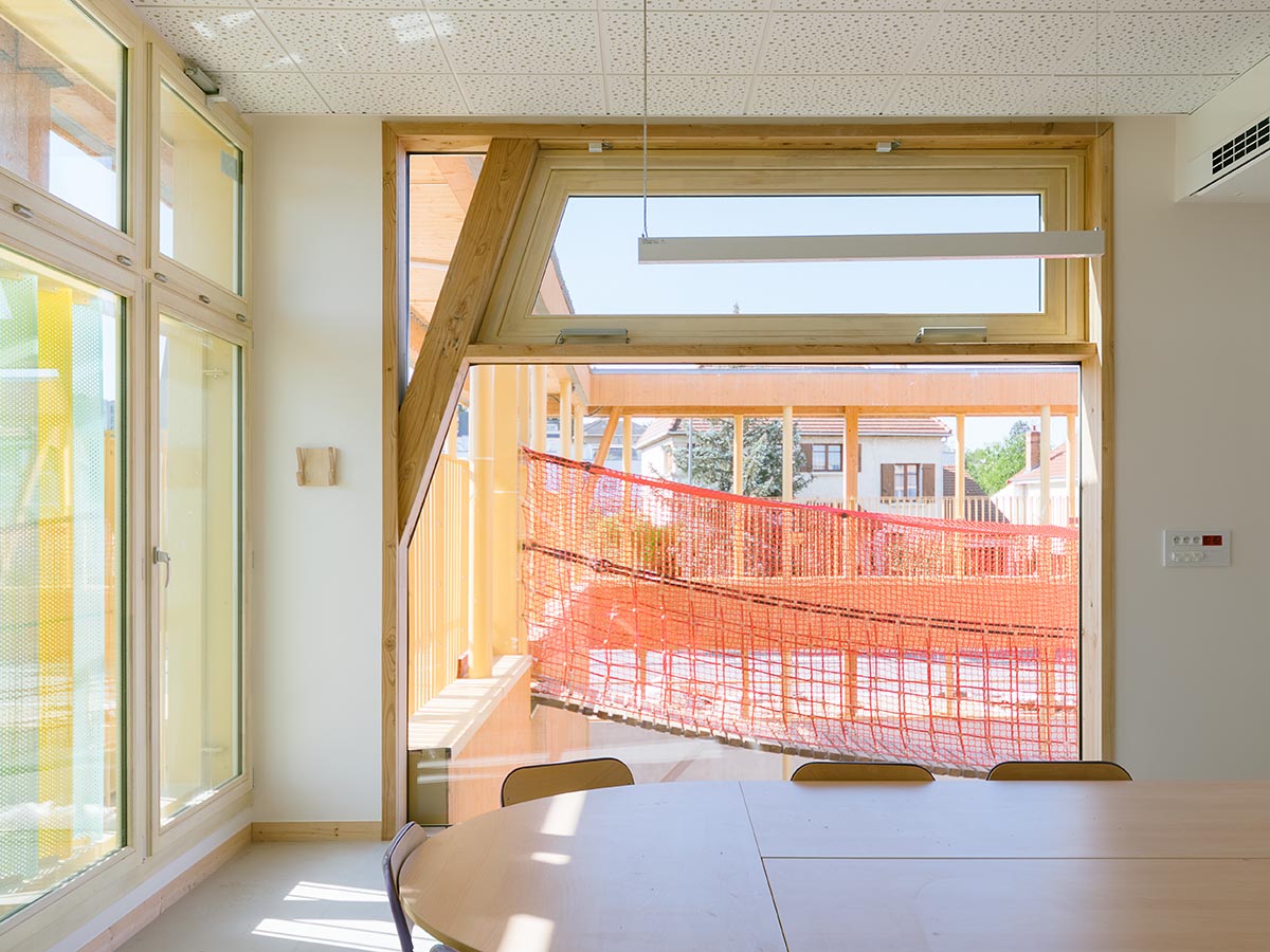 Wooden school by r2k architecte is inspired by Nordic architecture to be a positive energy building