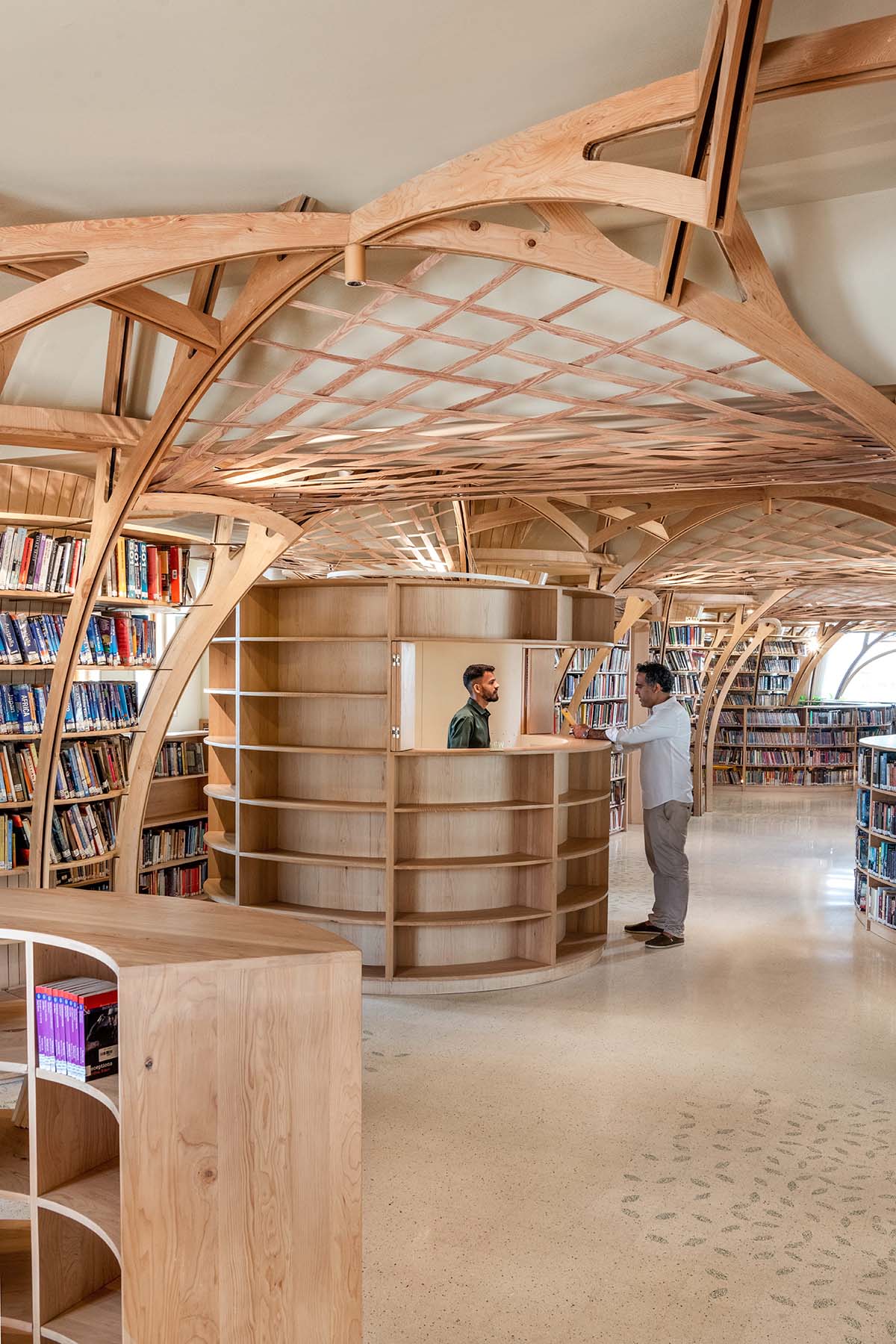 studio Hinge embeds a library under the wooden tree-like canopies in Mumbai