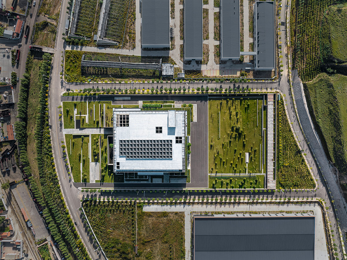 Grey brick walls wrap a factory building referencing to local construction methods in China 