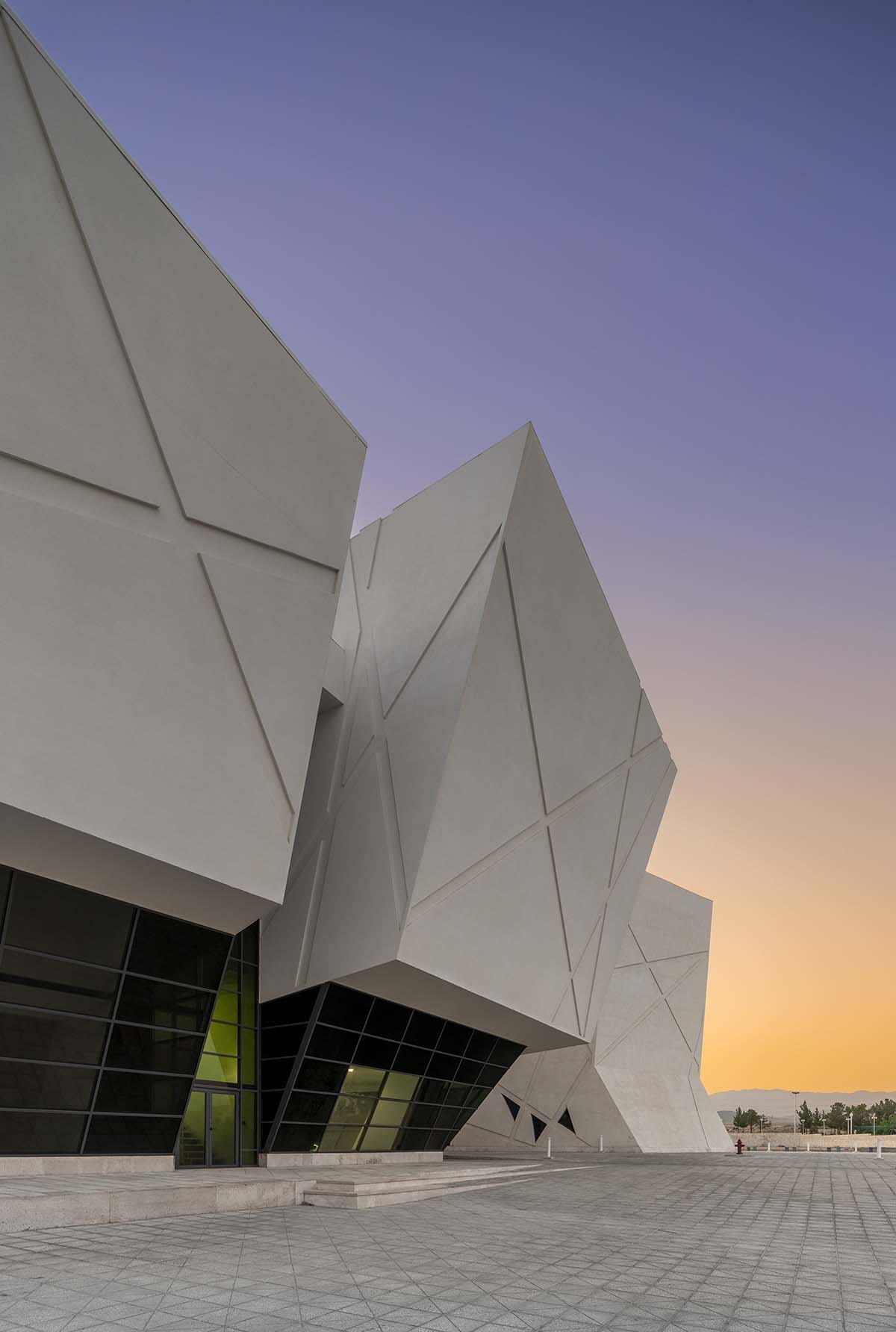 New monolithic auditorium and library at Semnan University features intricate openings and ribbons 