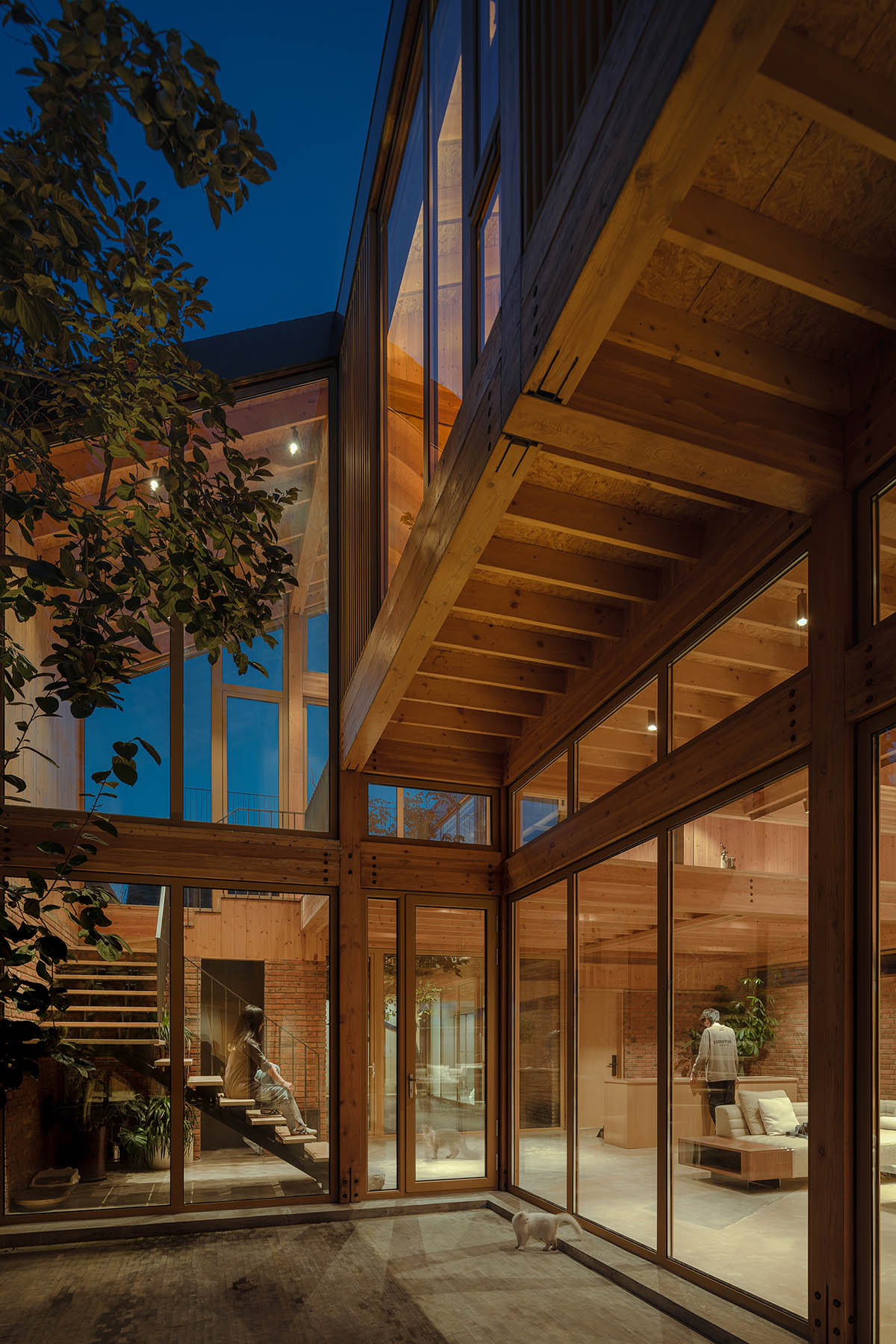 Archstudio renovates traditional Beijing courtyard house with interwoven wooden framework