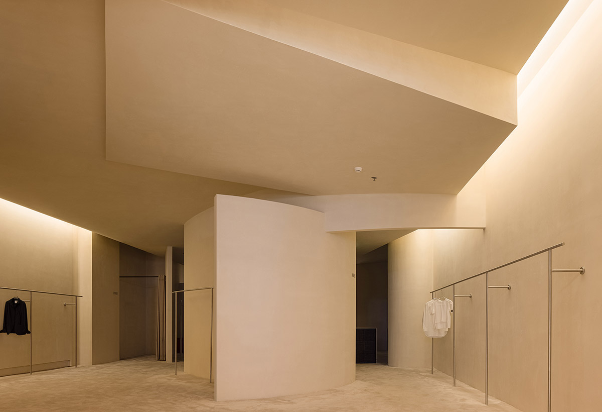 AD ARCHITECTURE designs store with light yellow curved walls that create comfort and softness 