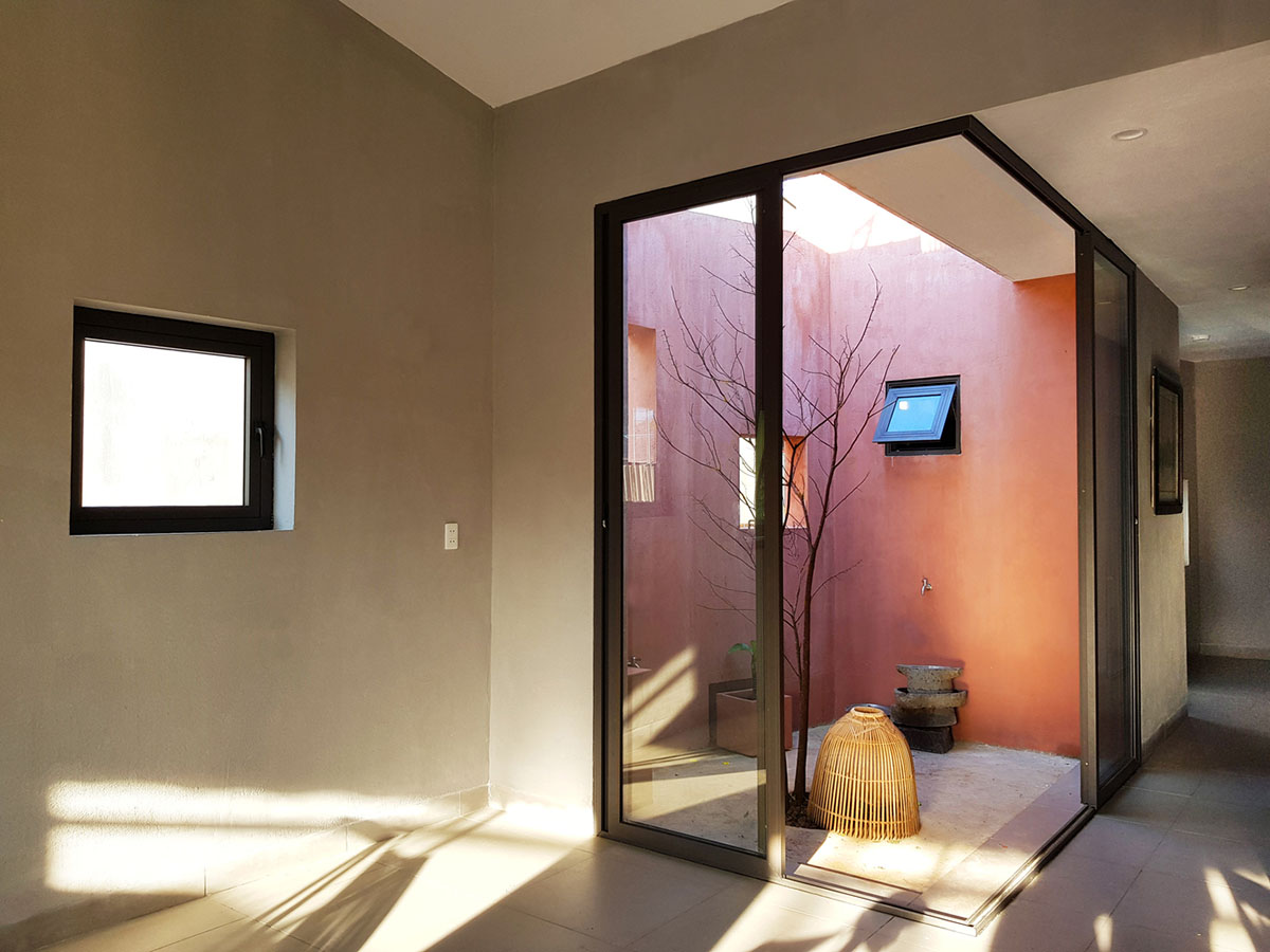 This reddish house features rooftop garden to make owners grow their own food in Vietnam