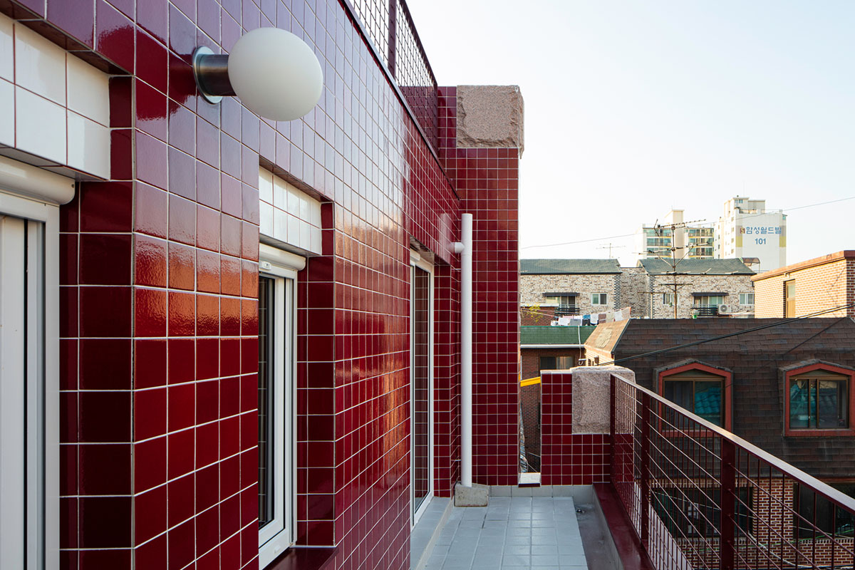 aoa architects uses red marble tiles to clad this apartment in South Korean neighborhood