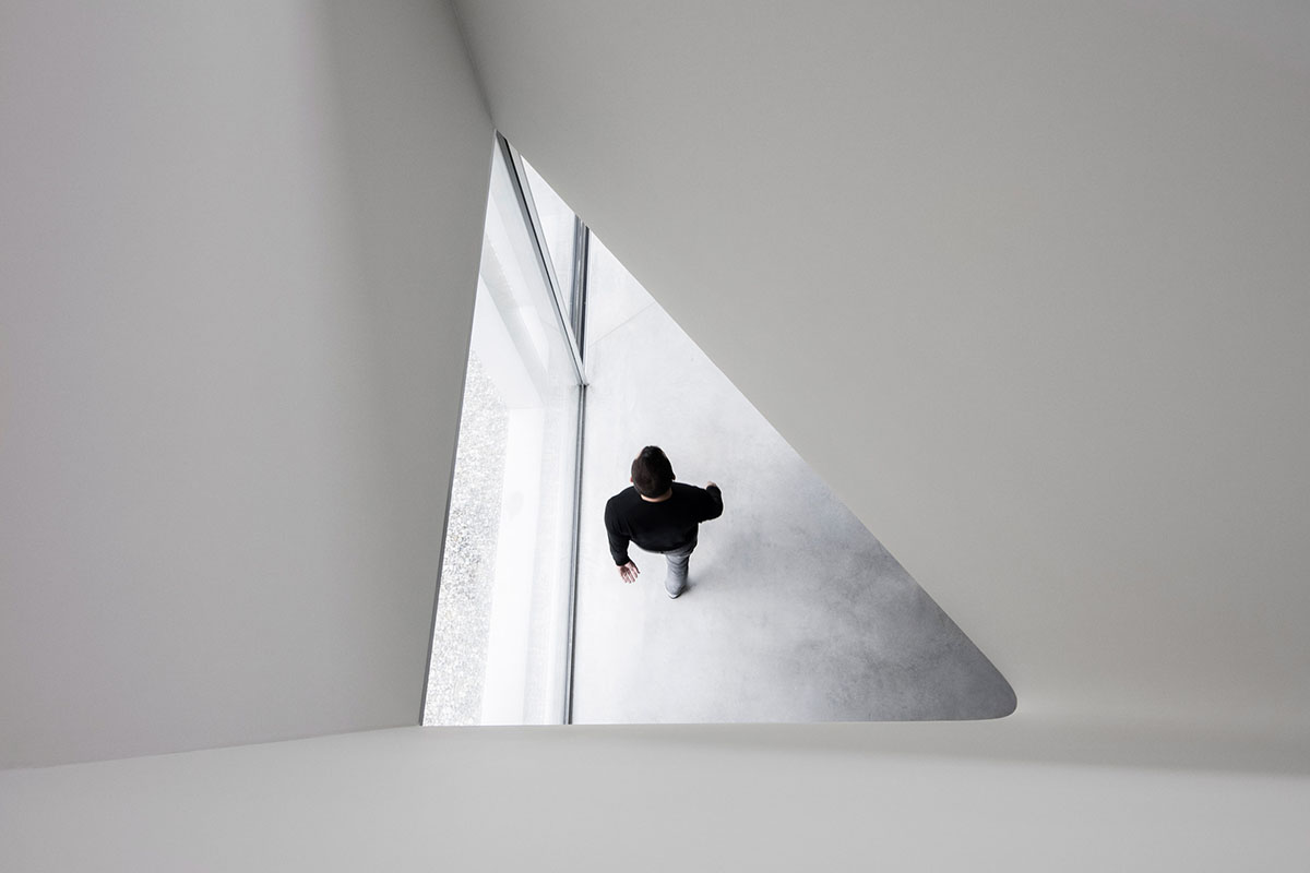 Grey concrete villa by DF_DC is characterised with trapezoidal colonnaded terrace on Comano hills