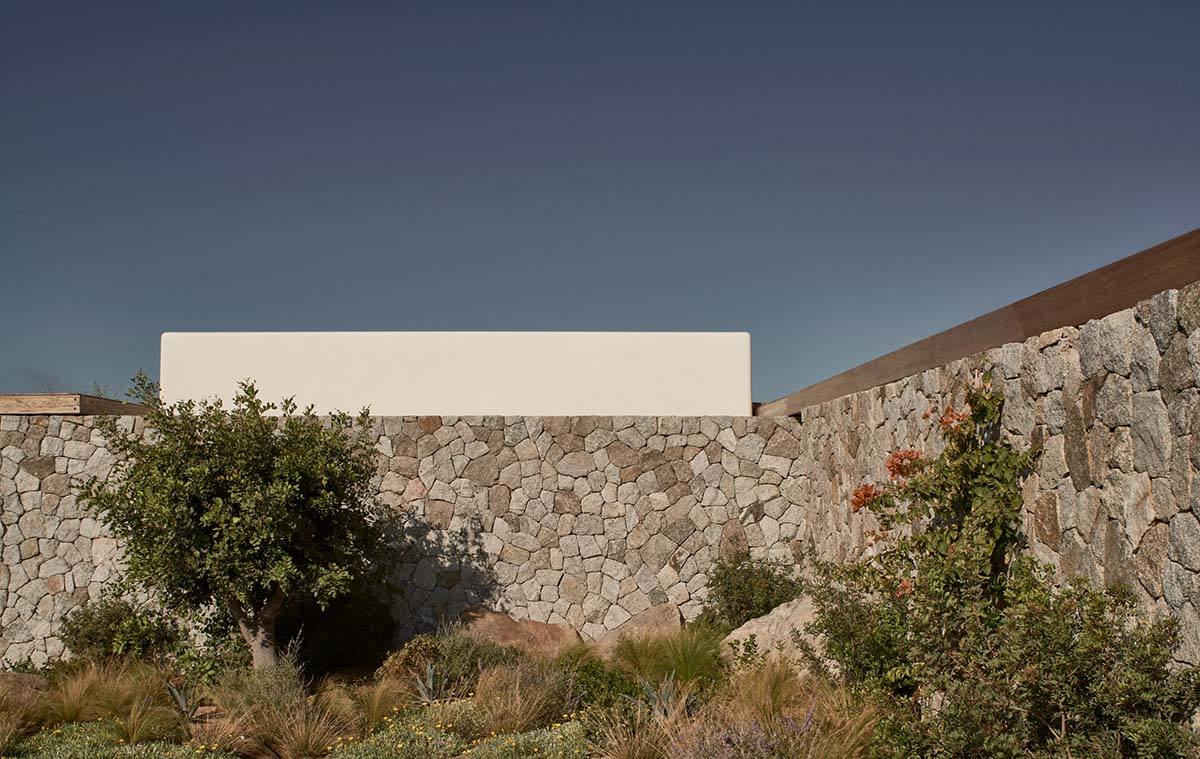 K Studio built small holiday villa with round-edged volumes and shading elements in Mykonos