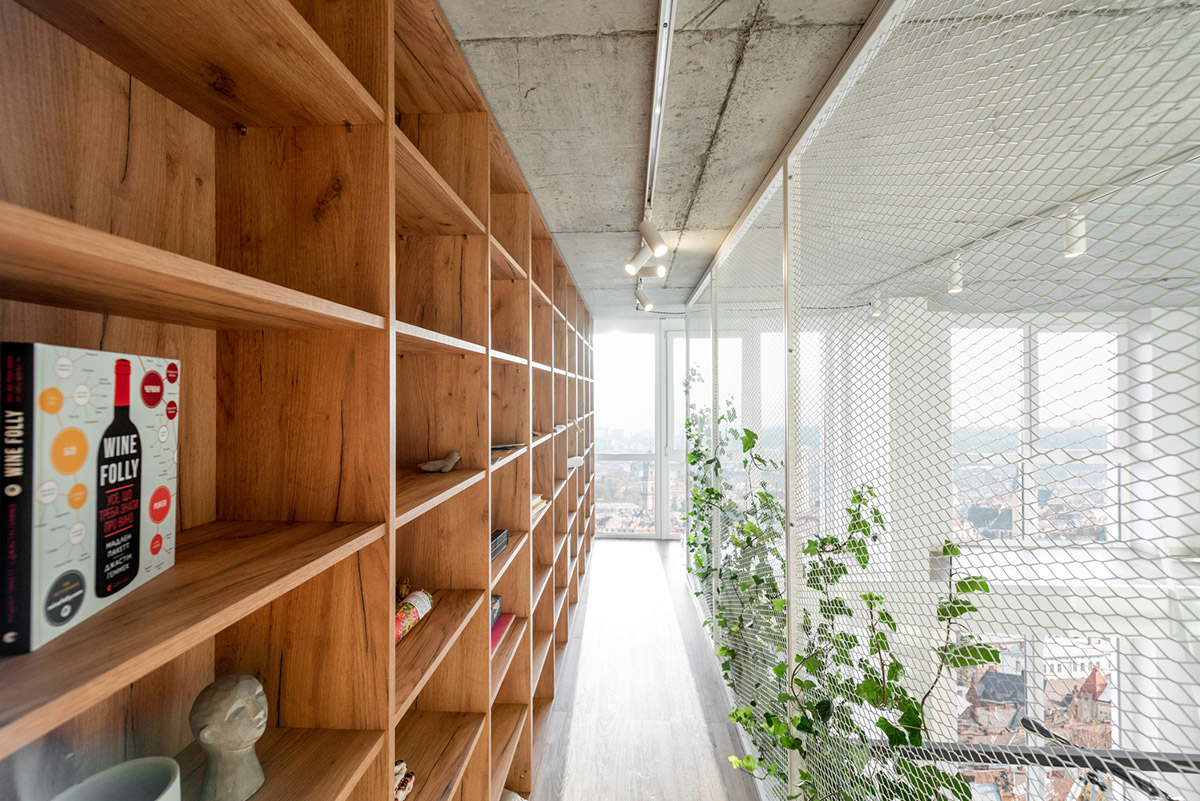 Metal framed-table, glass partitions, green infills make this interior space vivid and light in Lviv
