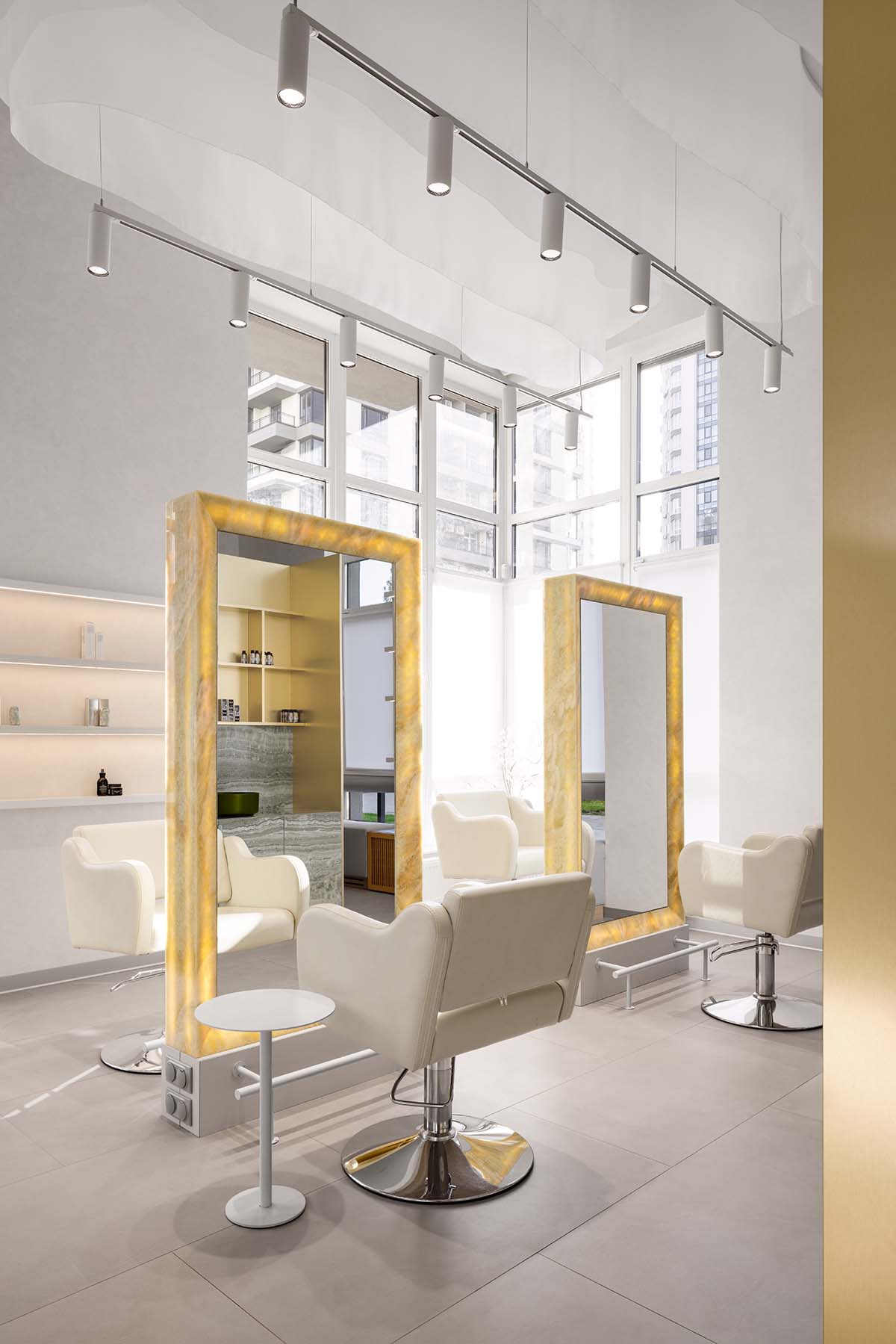 Mirrors and golden frames create a sense of care and deep comfort for beauty salon in Ukraine