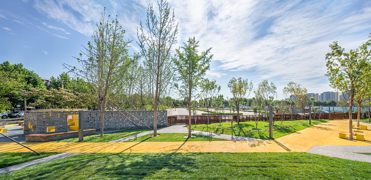 Crossboundaries designs community park with perforated grey brick walls ...