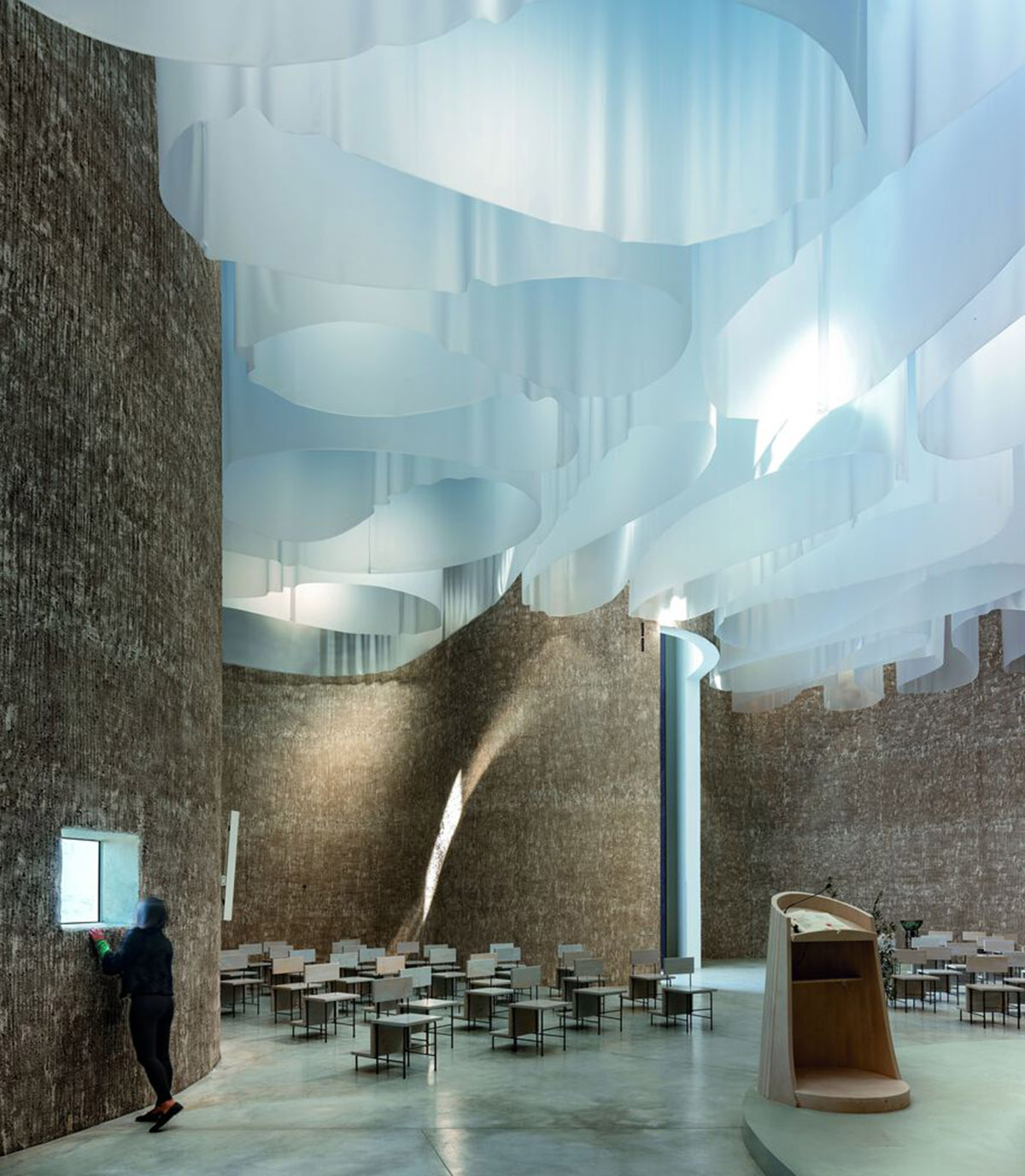 Smooth all-white walls form church designed by Mario Cucinella Architects in Mormanno hill town 