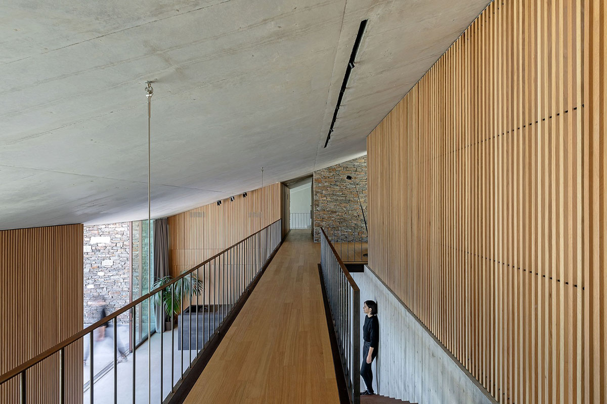 MOLD Architects used advantages of sloping land to design Ncaved house in Greece