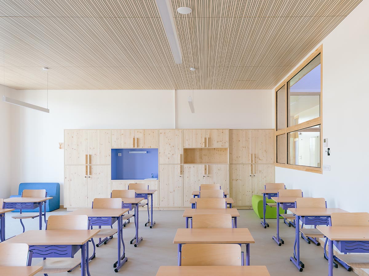 Wooden school by r2k architecte is inspired by Nordic architecture to be a positive energy building
