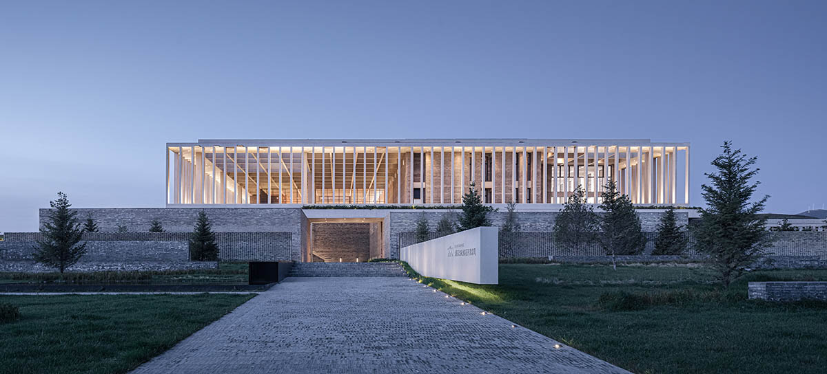 Grey brick walls wrap a factory building referencing to local construction methods in China 
