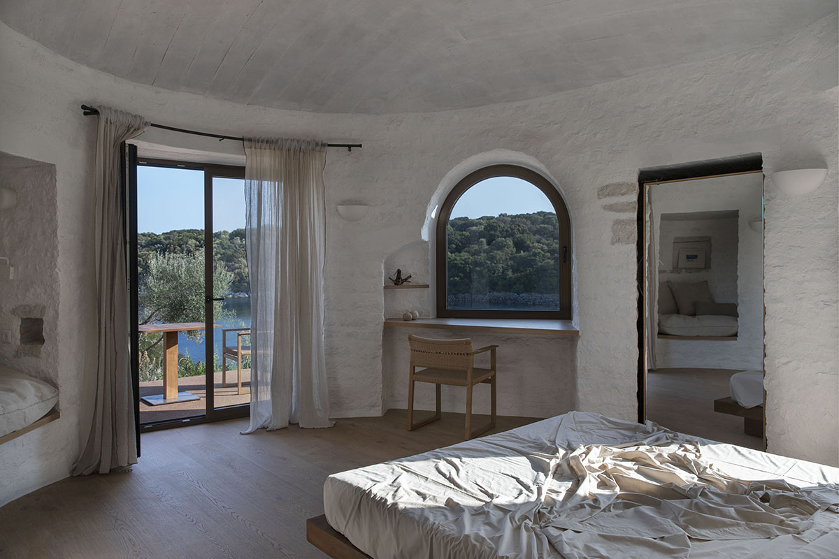 Pastoral round stone dwellings inform Meganisi House by Hiboux Architecture on Meganisi island