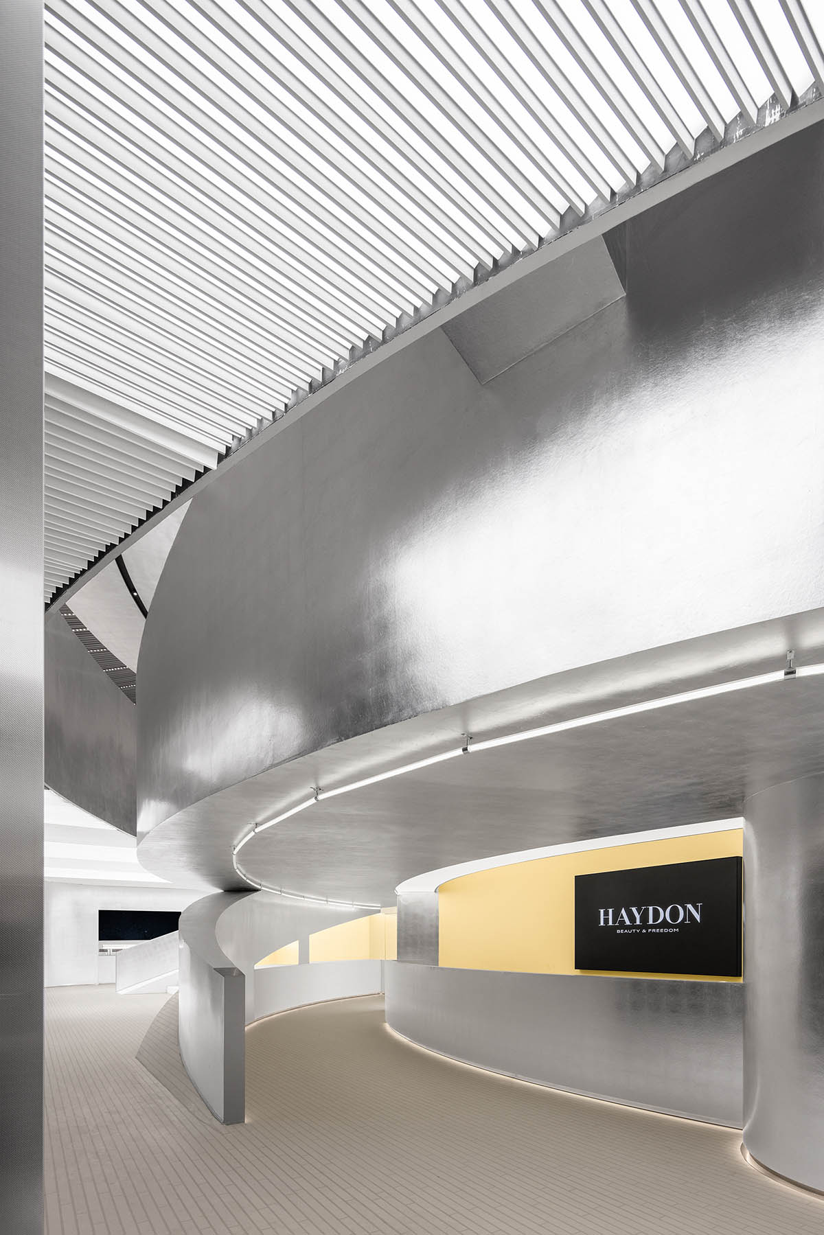 Various Associates designs beauty store with winding staircase and silver-toned interiors in Hangzhou