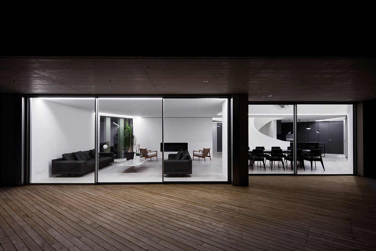 Grey concrete villa by DF_DC is characterised with trapezoidal colonnaded terrace on Comano hills