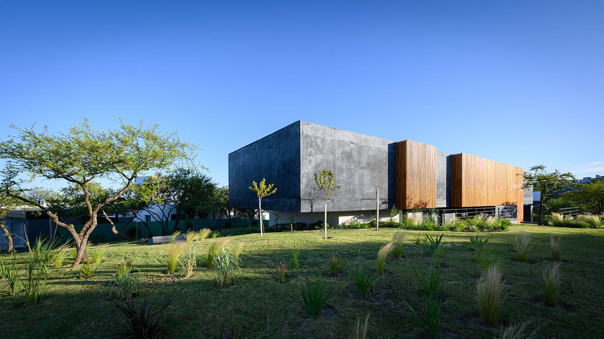 AR Arquitectos completes family home with black concrete and wooden cladding in Argentina 