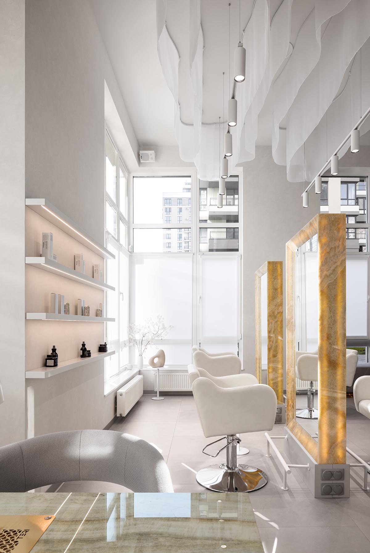 Mirrors and golden frames create a sense of care and deep comfort for beauty salon in Ukraine