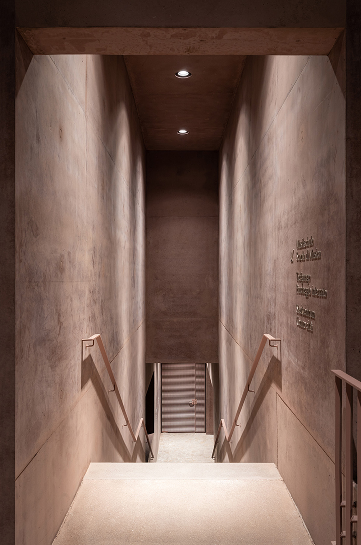 Carlana Mezzalira Pentimalli built music school with cut out and red-pigmented volumes in Italy