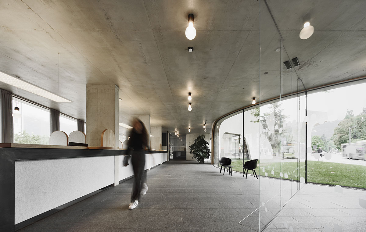 MoDusArchitects wraps public space with sinuous curves for an office building in Bolzano, Italy