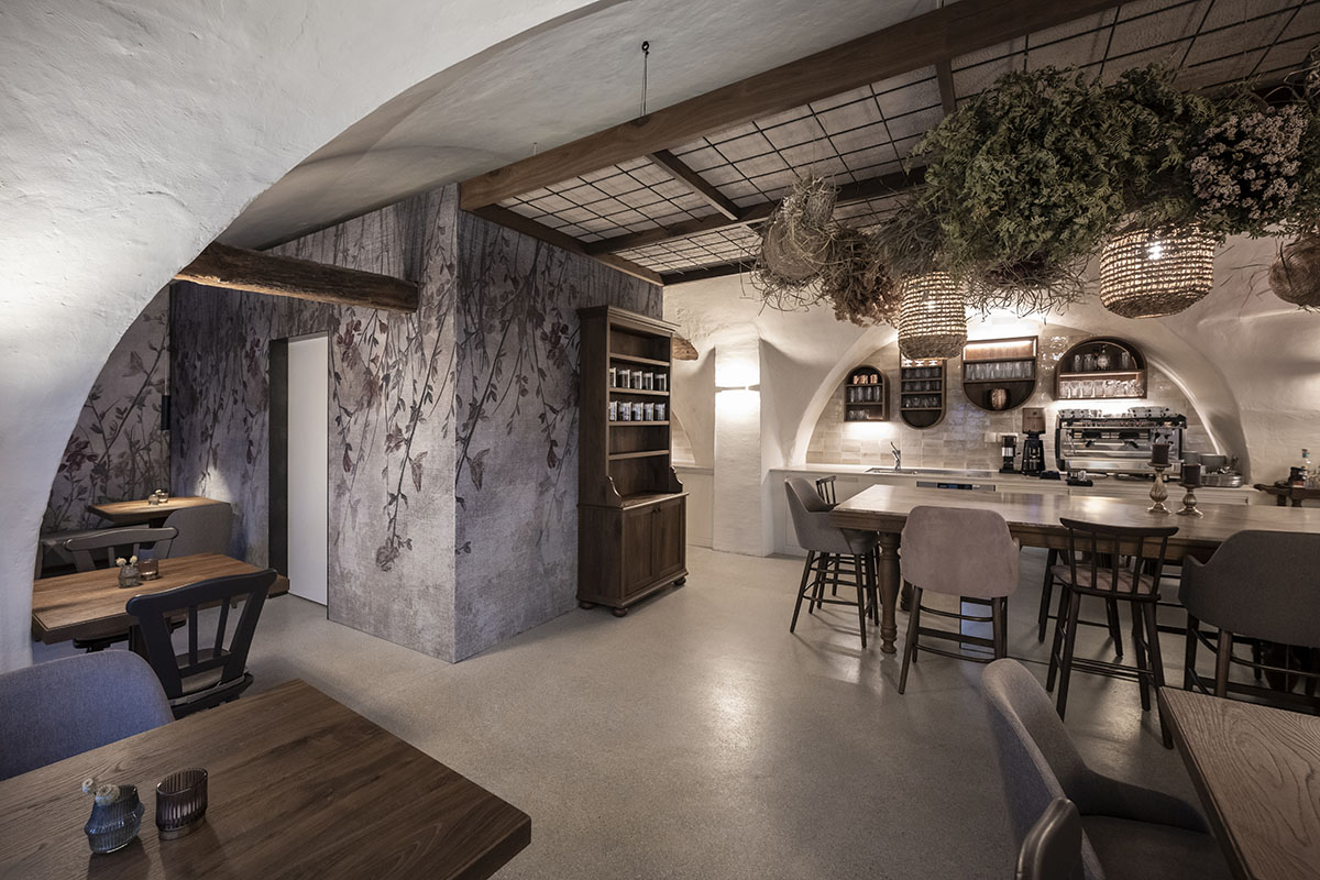 noa* transforms 19th-century workshop house into bohemian-style bistro with deep alcoves in Italy